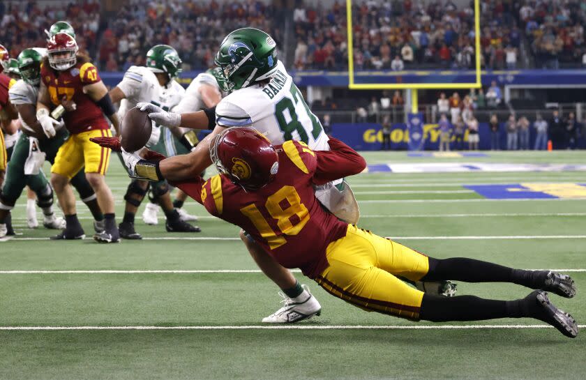 ARLINGTON, TX - JANUARY 2: Alex Bauman #87 of the Tulane Green Wave catches the winning touchdown pass as Eric Gentry #18 of the USC Trojans defends in the second half of the Goodyear Cotton Bowl Classic on January 2, 2023 at AT&T Stadium in Arlington, Texas. Tulane won 46-45. (Photo by Ron Jenkins/Getty Images)