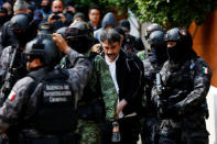 Accused drug kingpin Damaso Lopez (C), nicknamed "The Graduate", is escorted by police officers after he was arrested in Mexico City, Mexico May 2, 2017. REUTERS/Carlos Jasso