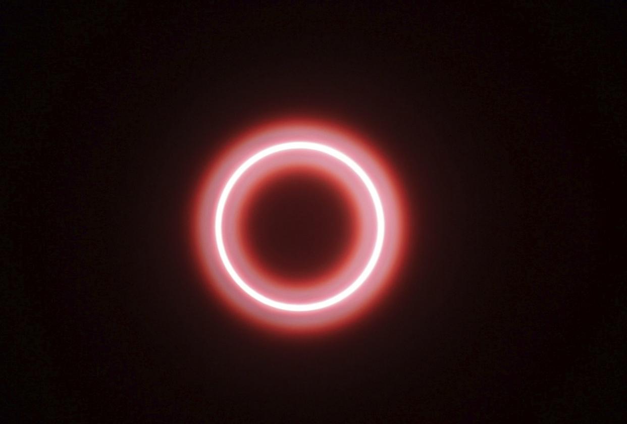 In this Thursday, Dec. 26, 2019, file photo, an annular "ring of fire" solar eclipse is seen through a safety glass from Siak, Riau province, Indonesia.