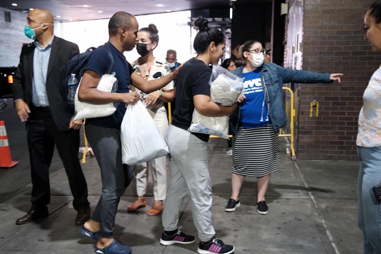 Migrants who crossed the border from Mexico into Texas exit a bus as it arrives into the Port Authority bus station in Manhattan on Aug. 25, 2022. 