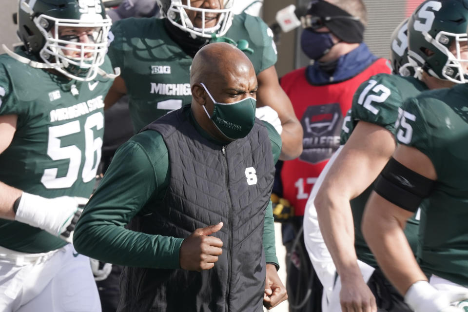 Michigan State head coach Mel Tucker runs onto the field before the first half of an NCAA college football game against Indiana, Saturday, Nov. 14, 2020, in East Lansing, Mich. (AP Photo/Carlos Osorio)