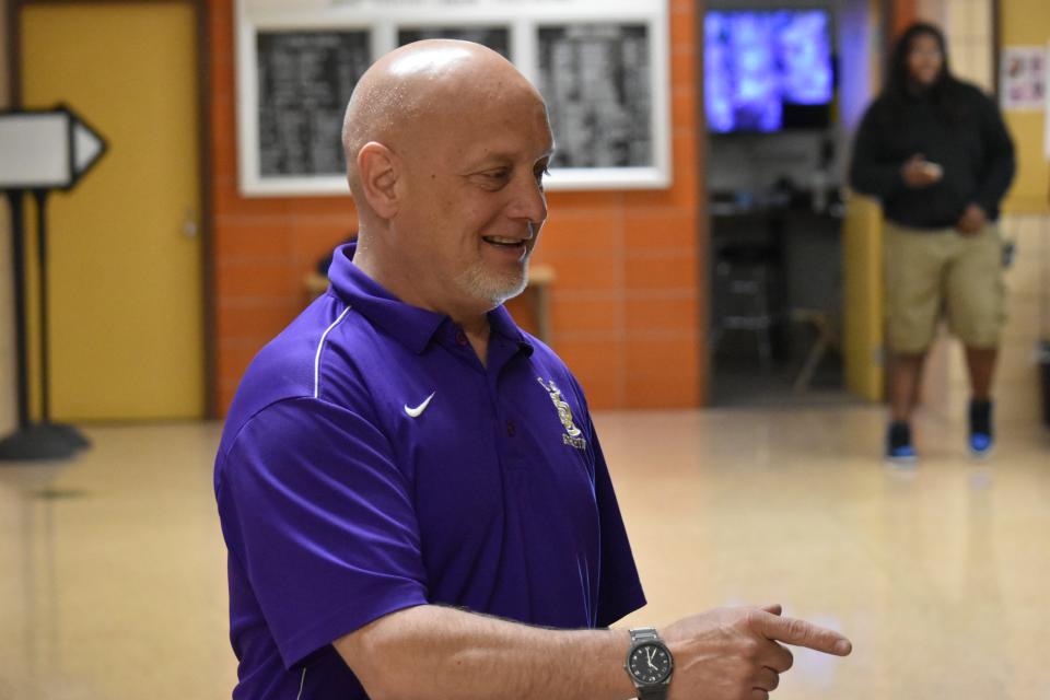 Clay High School Athletic Director Al Hartman points out old trophies won by teams he coached in the 1990s on Thursday, May 2, 2024. Hartman coached wrestling, football and golf at the school for over two decades before he was named the athletic director.