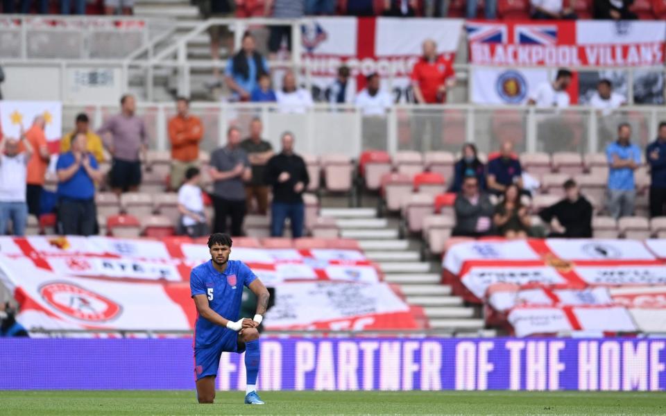 Tyrone Mings of England takes a knee in support of the Black Lives Matter movement prior to the international friendly match between England and Romania at Riverside Stadium on June 06 - Inside England's Supporters' Club: Even the most devoted fans are divided over taking the knee - FA COLLECTION