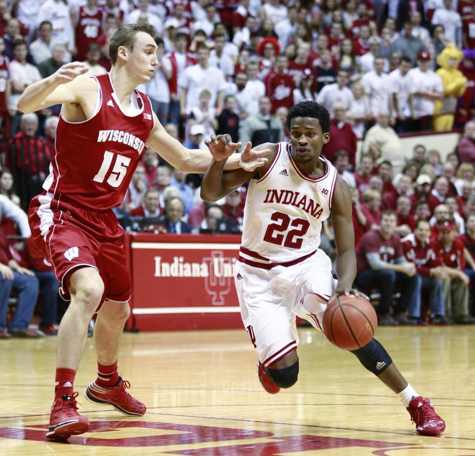 Indiana guard Stanford Robinson (22) drives with the basketball guarded by Wisconsin forward Sam Dekker (15) in the second half of an NCAA basketball game against Wisconsin in Bloomington, Ind., Tuesday, Jan. 14, 2014. Indiana won 75-72. (AP Photo/R Brent Smith)