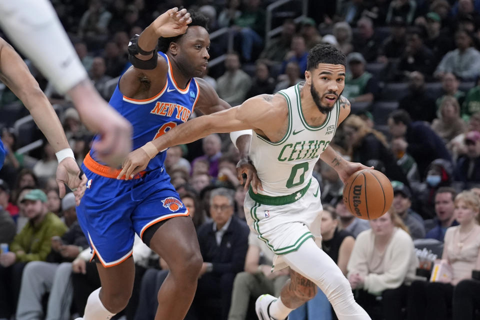 Boston Celtics forward Jayson Tatum (0) drives toward the basket as New York Knicks forward OG Anunoby (8) defends during the first half of an NBA basketball game Thursday, April 11, 2024, in Boston. (AP Photo/Steven Senne)