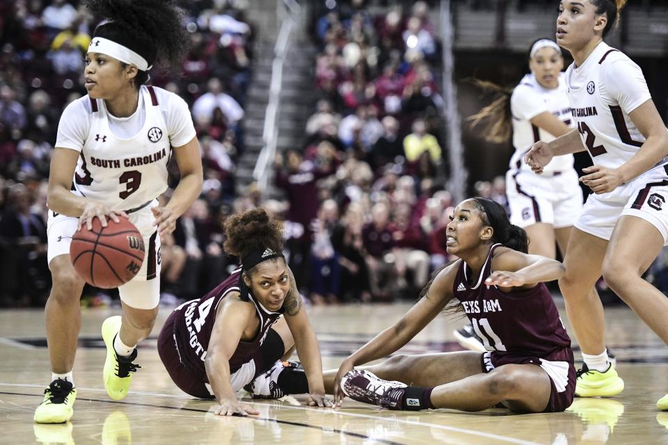 Texas A&M guard Shambria Washington (4) and Kayla Wells (11) react as South Carolina guard Destanni Henderson (3) grabs the ball during the second half of an NCAA college basketball game Sunday, March 1, 2020, in Columbia, S.C. (AP Photo/Sean Rayford)