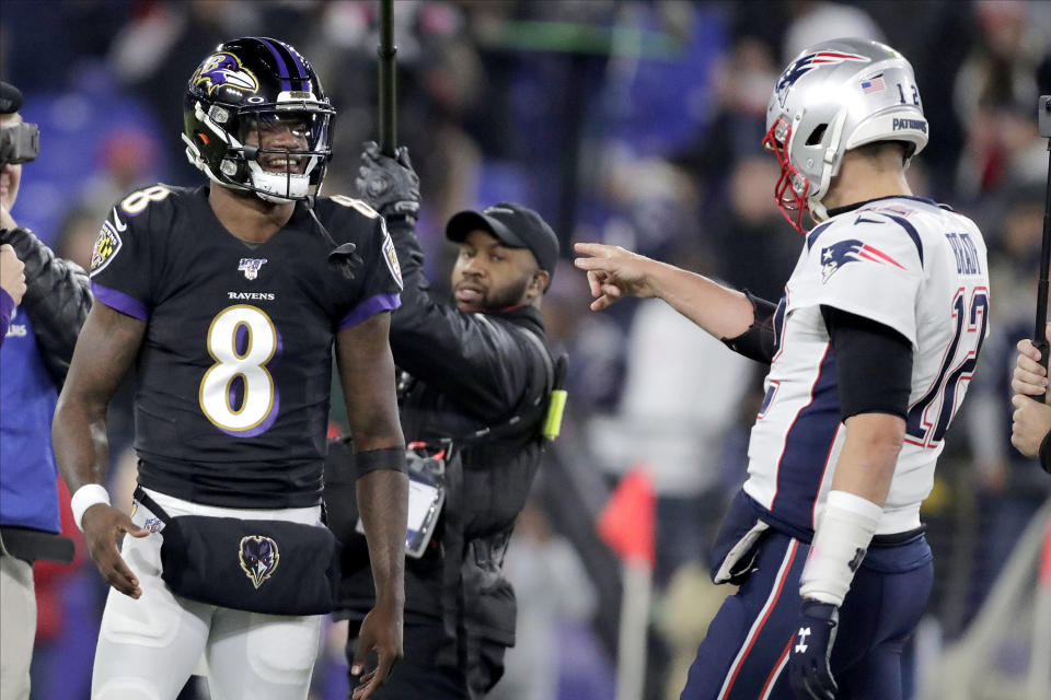 Baltimore Ravens quarterback Lamar Jackson (8) talks with New England Patriots quarterback Tom Brady prior to an NFL football game, Sunday, Nov. 3, 2019, in Baltimore. (AP Photo/Julio Cortez)