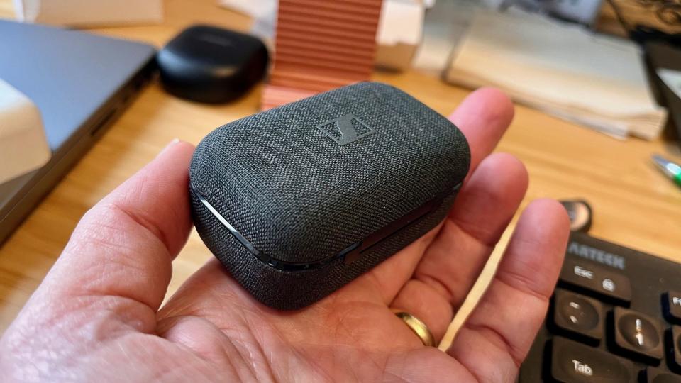 A close-up of the cloth-covered Momentum True Wireless 4 charging case.