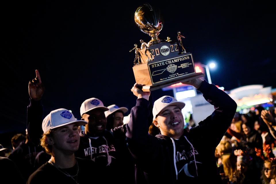 The West High School football team brings their 2022 state championship trophy to the Rocky Hill Christmas Parade Dec. 3.