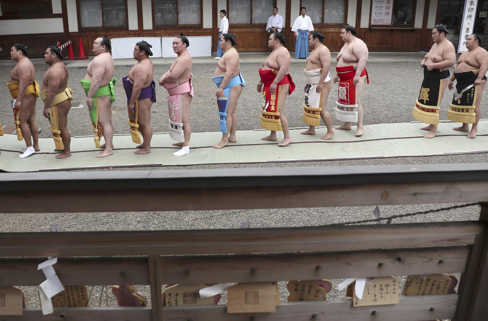Sumo wrestlers wait for prayers
