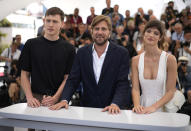 Harris Dickinson, from left, director Ruben Ostlund, and Charlbi Dean pose for photographers at the photo call for the film 'Triangle of Sadness' at the 75th international film festival, Cannes, southern France, Sunday, May 22, 2022. (AP Photo/Daniel Cole)