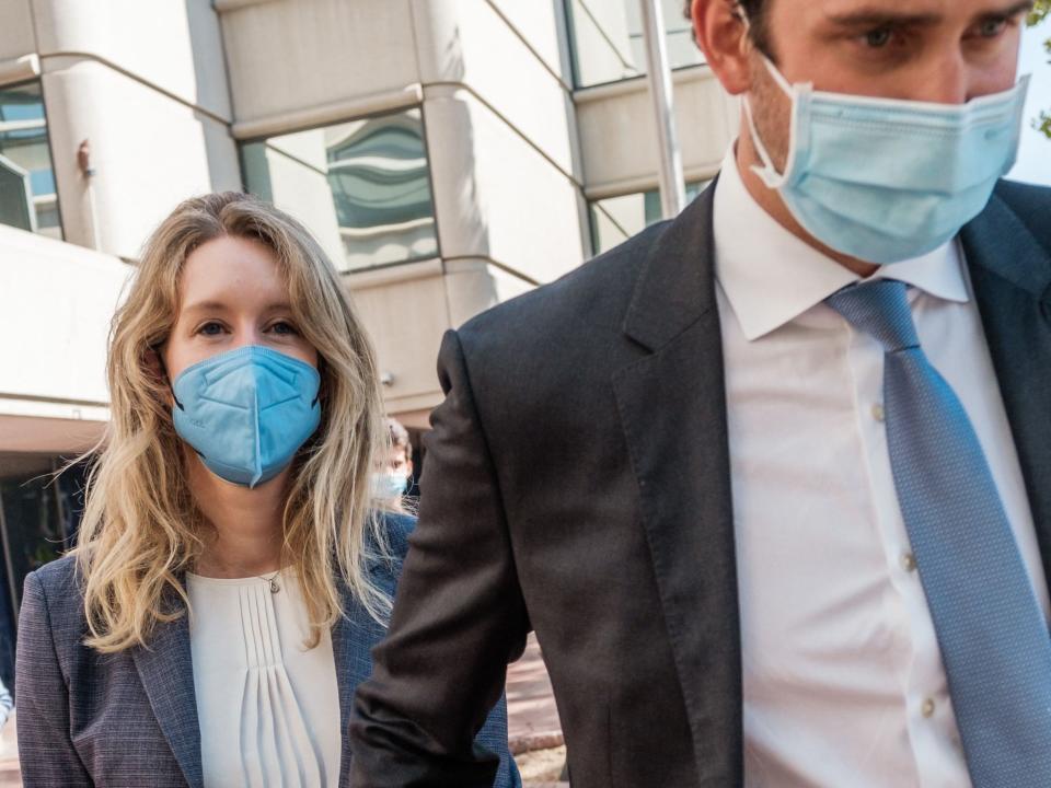 Elizabeth Holmes, founder and former CEO of blood testing and life sciences company Theranos, leaves the courthouse with her husband Billy Evans after the first day of her fraud trial in San Jose, California on September 8, 2021.