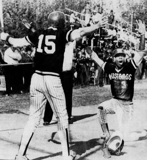 Karl Rhodes (3) of Western Hills exults after sliding home with the winning run in the Mustangs' 4-3 victory over top-seeded La Salle. Jerry Schoen (15), the on-deck batter, greets Rhodes.