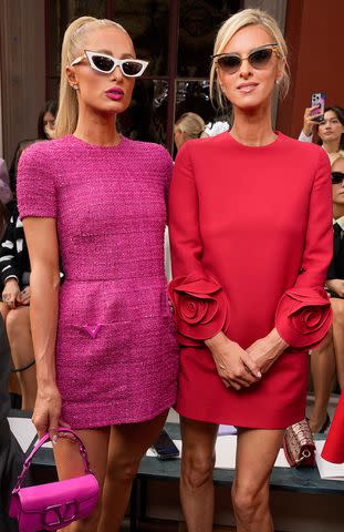 <p>Swan Gallet/WWD via Getty Images</p> Paris Hilton (left) and Nicky Hilton (right) at the Valentino show
