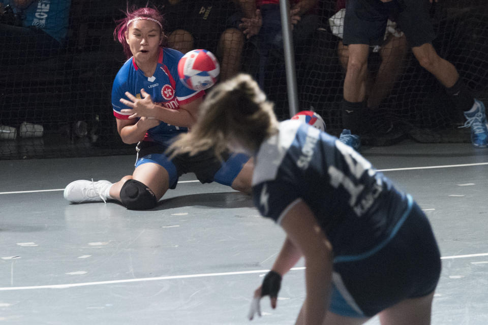 A Hong Kong player is hit by the ball during women's competition against Slovenia in the Dodgeball World Cup, Saturday, Aug. 4, 2018, in New York. (AP Photo/Mary Altaffer)
