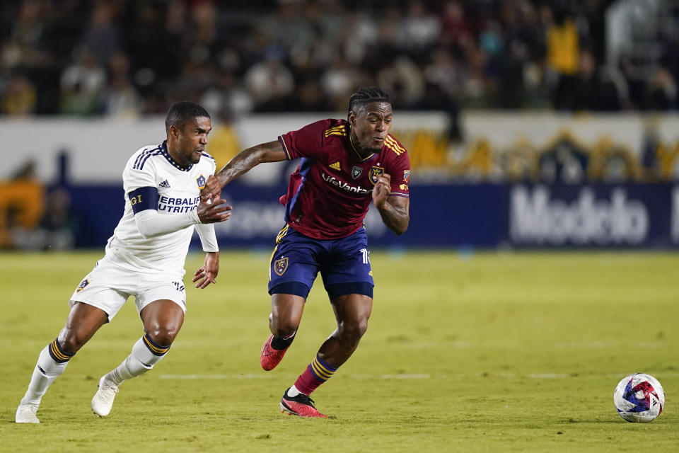 LA Galaxy forward Douglas Costa, left, and Real Salt Lake midfielder Nelson Palacio chase the ball during the first half of an MLS soccer match Saturday, Oct. 14, 2023, in Carson, Calif. (AP Photo/Ryan Sun)