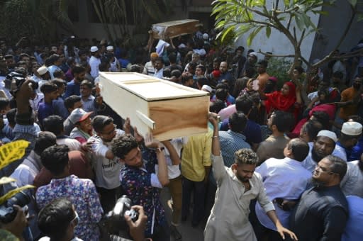 Relatives carry coffins of victims of the deadly fire which tore through apartment blocks in Bangladesh's capital Dhaka on Thursday