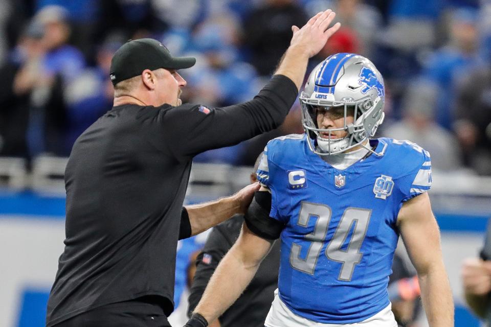 Lions coach Dan Campbell talks to linebacker Alex Anzalone during warmups before the NFC divisional playoff game between the Lions and Buccaneers at Ford Field on Sunday, Jan. 21, 2024.