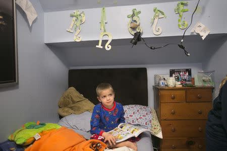 Rhett Krawitt, 6, sits on a bed in his home in Corte Madera, California January 28, 2015. Rhett is recovering from leukemia and his father is concerned his child could succumb to an outbreak of measles at his Northern California school. Krawitt is asking officials to bar entry to any student not vaccinated because of a family's personal beliefs. REUTERS/Elijah Nouvelage