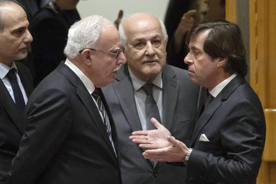 Palestinian Minister of Foreign Affairs Riyad al-Maliki, left, and French Ambassador to the UN Nicolas de Riviere, right, talk before a Security Council meeting at United Nations headquarters, Tuesday, Jan. 23, 2024. (AP Photo/Yuki Iwamura)