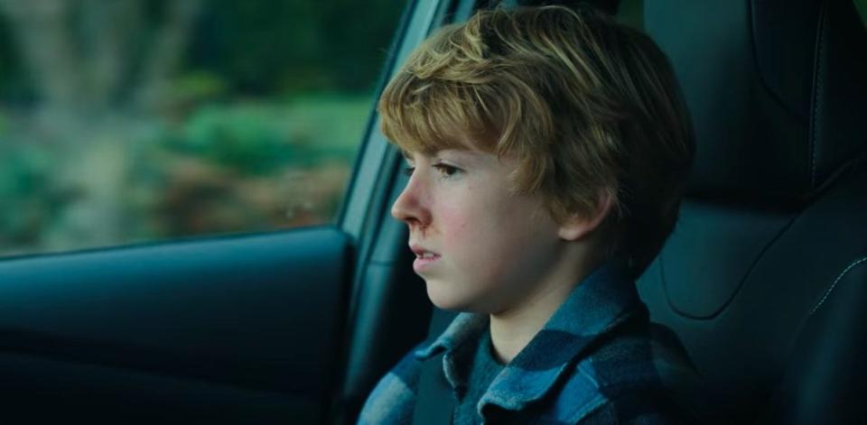 Young Adam sitting in his mom's car in "The Adam Project"