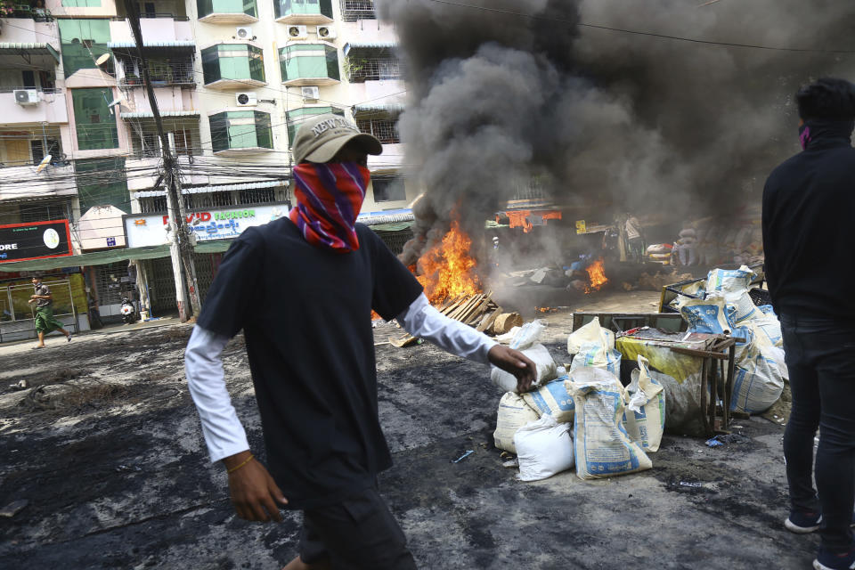 An anti-coup protester walks around the makeshift barricade during a demonstration in Yangon, Myanmar, Sunday, March 28, 2021. Protesters in Myanmar returned to the streets Sunday to press their demands for a return to democracy, just a day after security forces killed more than 100 people in the bloodiest day since last month's military coup. (AP Photo)