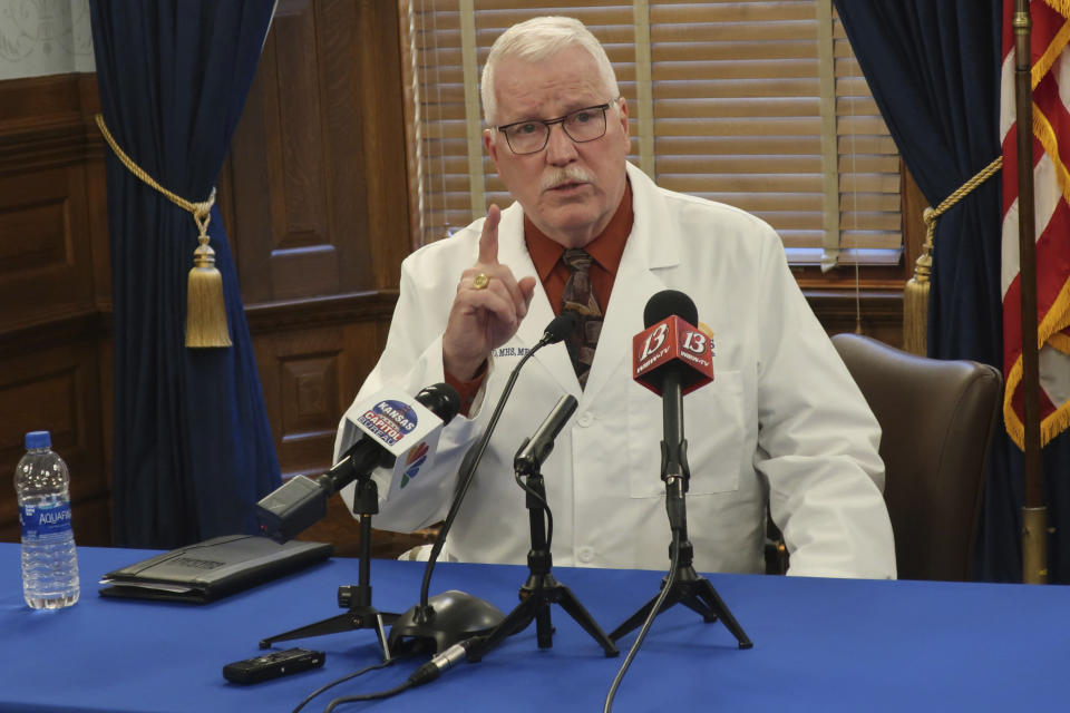 Dr. Lee Norman, the head of the Kansas Department of Health and Environment, answers questions from reporters during a news conference about the coronavirus pandemic, Wednesday, Oct. 7, 2020, at the Statehouse in Topeka, Kan. Norman says the state's hospitals will be stressed this fall and winter because of the pandemic and the state's annual flu season. (AP Photo/John Hanna)