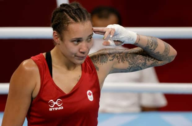 Tammara Thibeault of Canada gestures after winning her Olympic boxing match against Nadezhda Ryabets of Kazakhstan on Wednesday in Tokyo. (Ueslei Marcelino/Reuters - image credit)