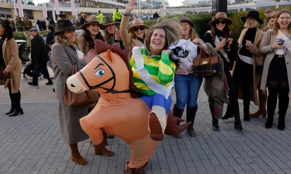 <span>A bride-to-be dressed as a horse and jockey with a hen party at the Cheltenham Festival.</span><span>Photograph: Tom Jenkins/The Guardian</span>