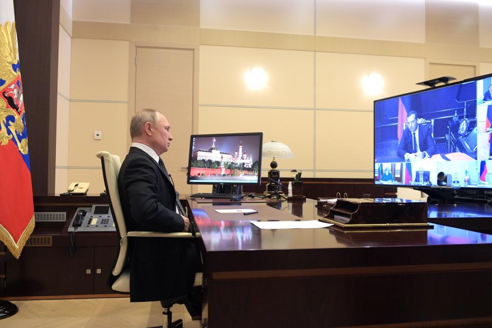 Russian President Vladimir Putin chairs a Security Council meeting at the Novo-Ogaryovo residence outside Moscow, Russia, Thursday, April 16, 2020. Russian President Vladimir Putin has ordered the postponement of a Victory Day parade marking the 75th anniversary of the end of World War II, citing the ongoing public health threat from the coronavirus pandemic. Speaking in televised remarks on Thursday, Putin said the festivities would be held later this year. (Alexei Druzhinin, Sputnik, Kremlin Pool Photo via AP)