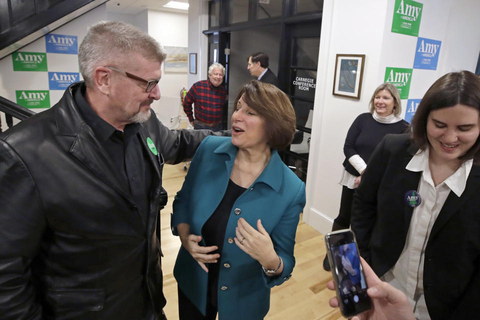 Democratic presidential candidate Sen. Amy Klobuchar, D-Minn., speaks to a potential voter at a campaign event, Tuesday, Dec. 3, 2019, in Milford, N.H. (AP Photo/Elise Amendola)