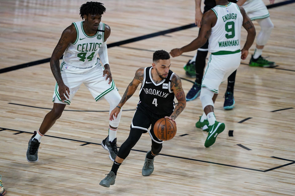 Brooklyn Nets guard Chris Chiozza (4) is defended by Boston Celtics center Robert Williams III (44) during the first half of an NBA basketball game Wednesday, Aug. 5, 2020 in Lake Buena Vista, Fla. (AP Photo/Ashley Landis)