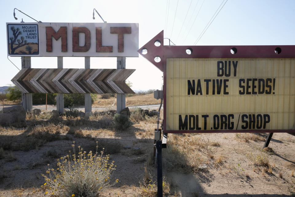 The Mojave Desert Land Trust sign is posted outside its headquarters on Highway 62 in the Mojave Desert near Joshua Tree, Calif., Wednesday, June 12, 2023. (AP Photo/Damian Dovarganes)