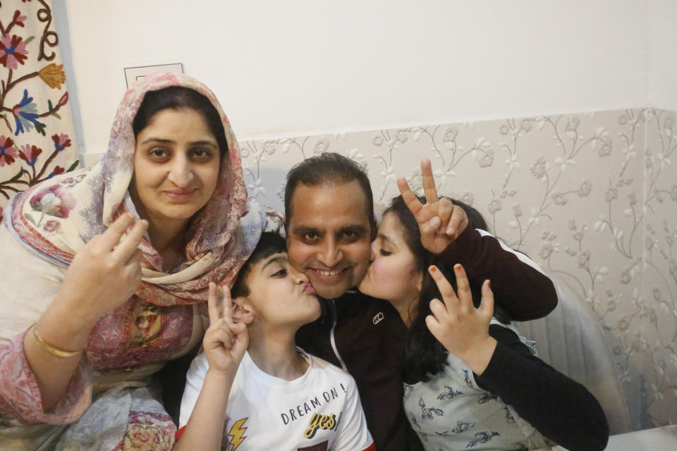 Associated Press photographer Mukhtar Khan celebrates with his family at his home in Srinagar, Indian controlled Kashmir, Tuesday, April 5, 2020, following the announcement that he was one of three AP photographers who won the Pulitzer Prize in Feature Photography for their coverage of the conflict in Kashmir and in Jammu, India. (AP Photo/Afnan Arif)
