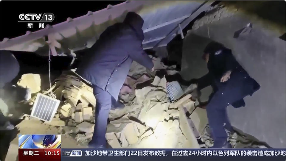 In this image taken from video footage run by China's CCTV, rescuers work near the rubble from an earthquake in Kizilsu Kirghiz Autonomous Prefecture, China’s western Xinjiang region Tuesday, Jan. 23, 2024. A strong earthquake struck China’s far western Xinjiang region early Tuesday, knocking out power and destroying homes, local authorities and state media reported. (CCTV via AP)