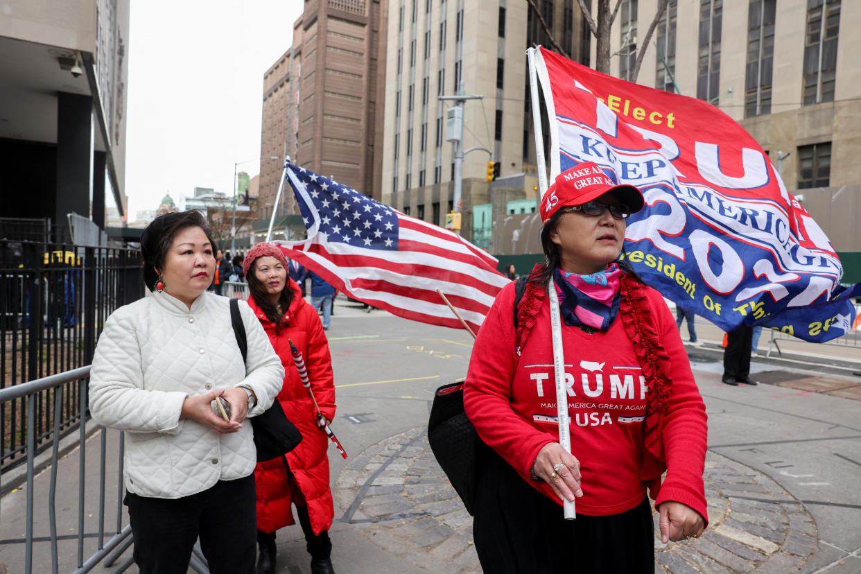 Supporters of former President Donald Trump arrive at the Manhattan Criminal Courthouse after Trump's indictment by a Manhattan grand jury following a probe into hush money paid to porn star Stormy Daniels, in New York City, U.S, April 3, 2023.  REUTERS/Caitlin Ochs