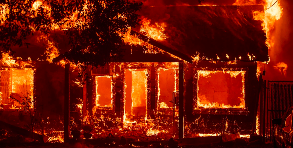 A home burns as the Camp Fire tears through Paradise, California, on November 8, 2018.