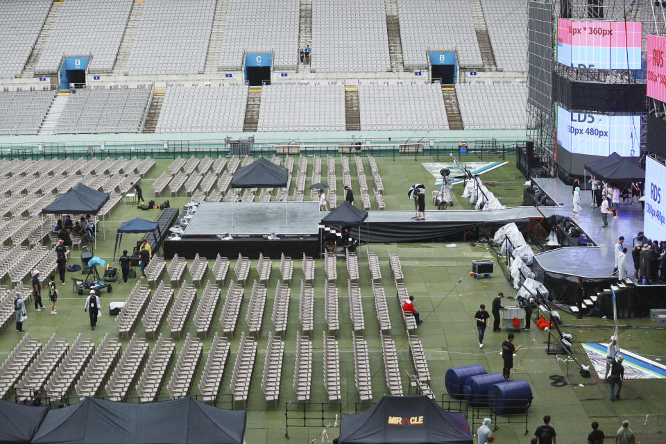 Workers check for the closing ceremony of the World Scout Jamboree and the "K-pop super live" concert at the World Cup Stadium in Seoul, South Korea, Friday, Aug. 11, 2023. Flights and trains resumed and power was mostly restored Friday after a tropical storm blew through South Korea, which was preparing the pop concert for 40,000 Scouts whose global Jamboree was disrupted by the weather. (Jin Yeon-soo/Yonhap via AP)