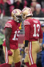 San Francisco 49ers quarterback Brock Purdy (13) is congratulated by wide receiver Deebo Samuel (19) after scoring a touchdown against the Tampa Bay Buccaneers during the first half of an NFL football game in Santa Clara, Calif., Sunday, Dec. 11, 2022. (AP Photo/Tony Avelar)