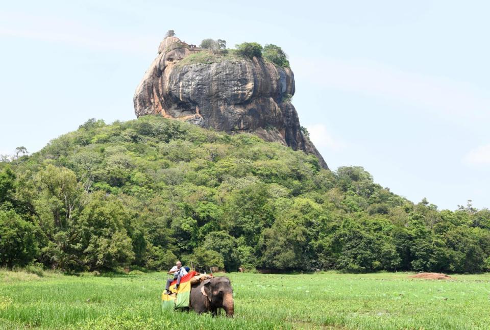 <div class="inline-image__caption"><p>Sri Lankan tourists ride on an elephant during a sightseeing tour in the ancient Sri Lankan city of Sigiriya, about 100 miles north of Colombo.</p></div> <div class="inline-image__credit">Lakruwan Wanniarachichi/Getty</div>