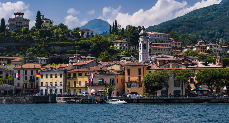 View of the lakeside of town, including the Church of Santo Stefano, across Lake Como from a ferryboat. (Photo by Frank Bienewald/LightRocket via Getty Images)