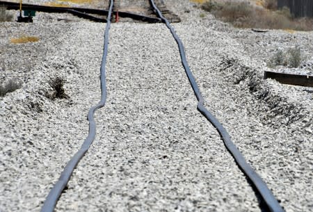 Railroad tracks bent by an eartquake lie in a railbed near Trona