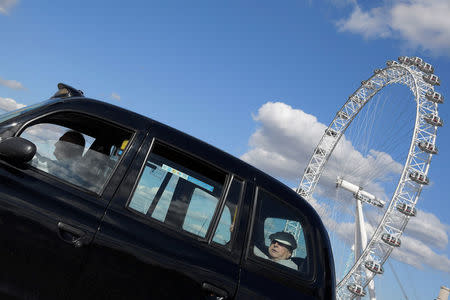 A taxi drives past the London Eye in central London, Britain September 22, 2017. REUTERS/Toby Melville