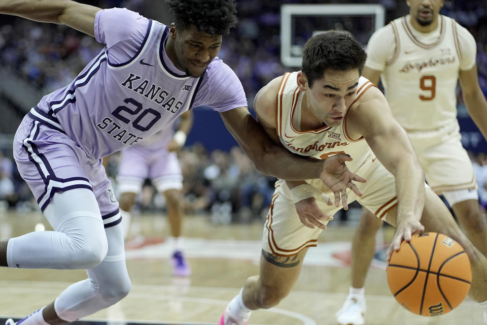 Kansas State forward Jerrell Colbert (20) and Texas forward Brock Cunningham chase a loose ball during the first half of an NCAA college basketball game Wednesday, March 13, 2024, in Kansas City, Mo. (AP Photo/Charlie Riedel)