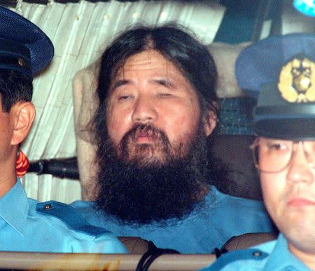 Japanese doomsday cult leader Shoko Asahara sits in a police van following an interrogation in Tokyo, Japan, in this photo taken by Kyodo September 25, 1995. Mandatory credit Kyodo/via REUTERS