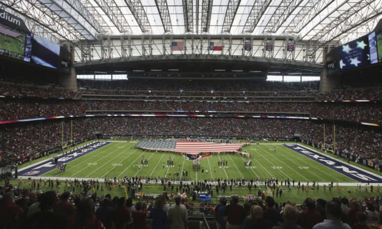 A view of the Texans stadium with an American flag on the field.