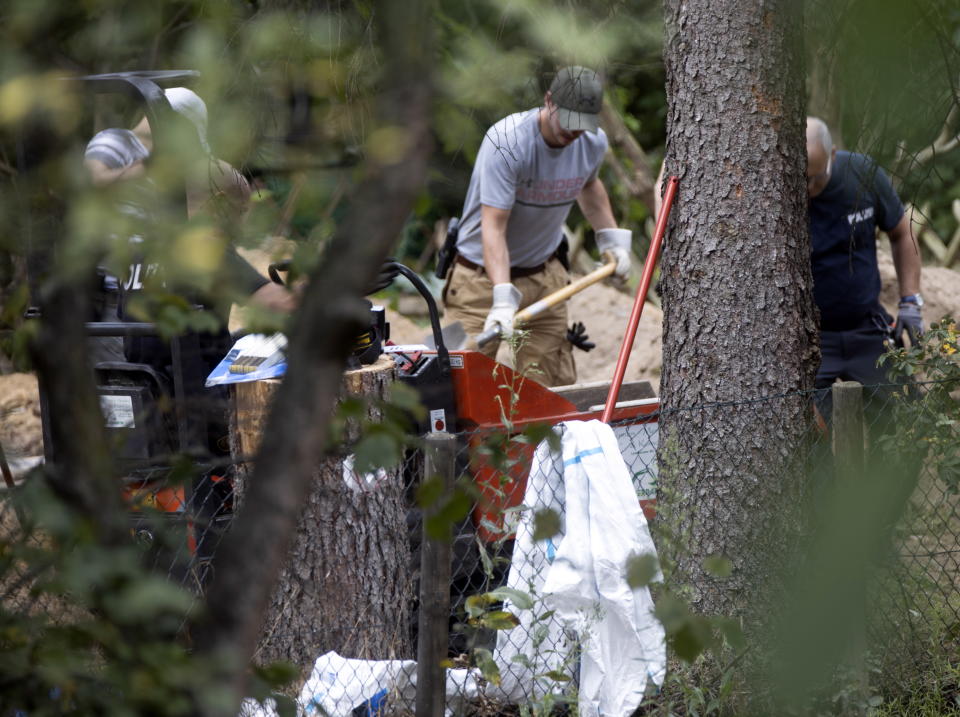 Police officers dig and search the garden plot. Source: AP