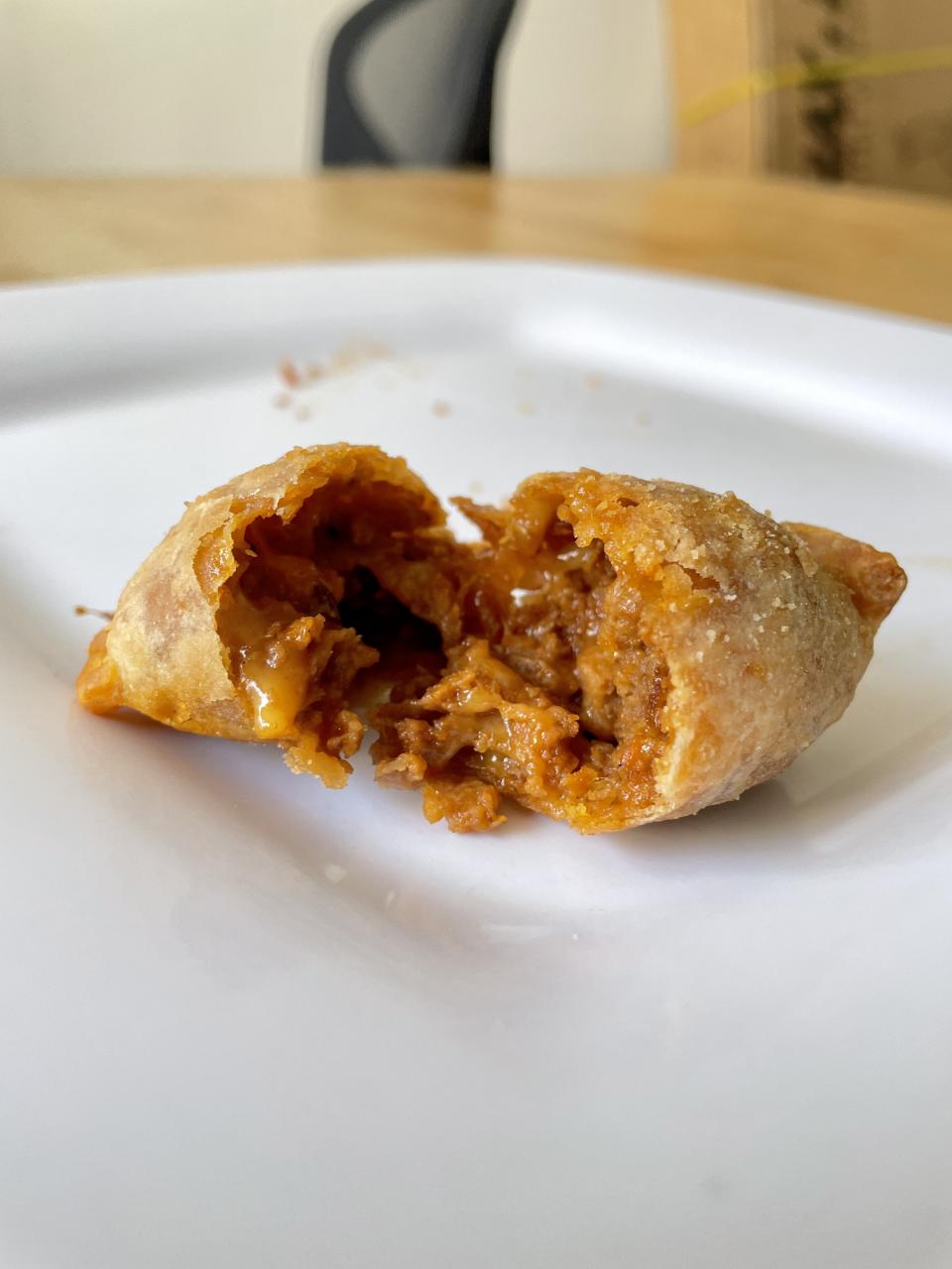 A broken empanada on a plate