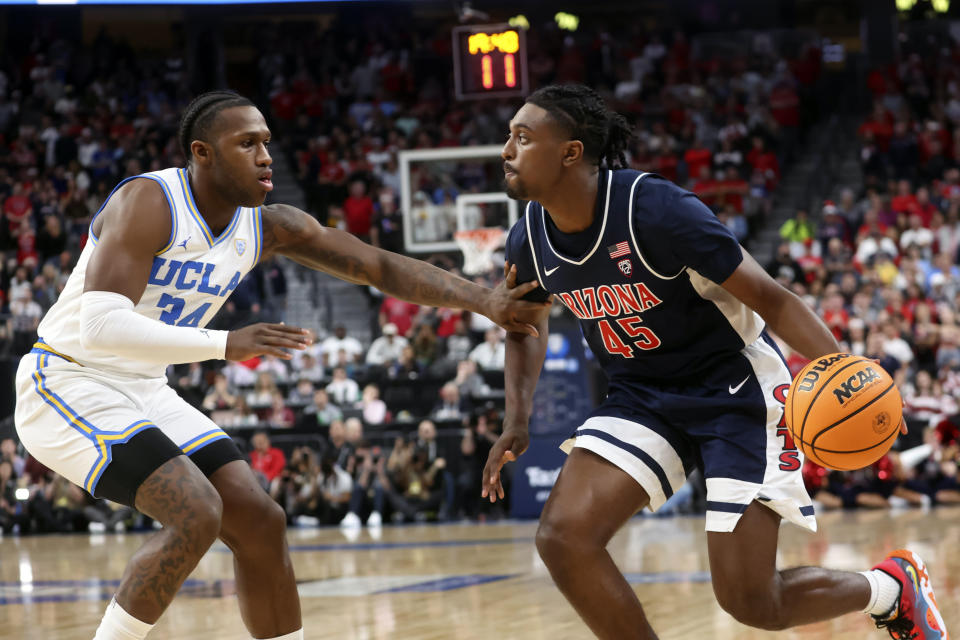 Arizona guard Cedric Henderson Jr. (45) drives the ball against UCLA guard David Singleton (34) during the first half of an NCAA college basketball game in the championship of the Pac-12 tournament, Saturday, March 11, 2023, in Las Vegas. (AP Photo/Chase Stevens)