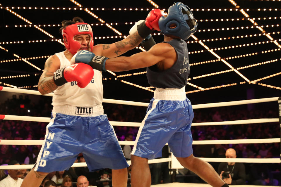 <p>John Chalen (red) battles Reshawn Merrick (blue) in the Bronx Precinct Callout during the NYPD Boxing Championships at the Hulu Theater at Madison Square Garden on March 15, 2018. (Gordon Donovan/Yahoo News) </p>